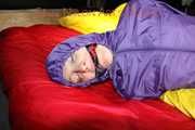 Sonja tied, gagged and hooded with ropes and a cloth gag on the sofa wearing a supersexy blue rain pants and a purple rain jacket (Pics)