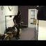 Stella during dressing up for a shooting wearing shiny nylon rainwear (Video)