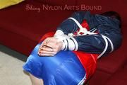 Jill tied and gagged on a sofa wearing a shiny nylon shorts and a rain jacket (Pics)