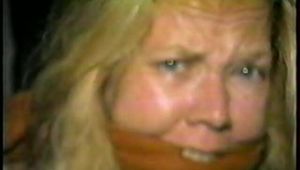 38 Yr OLD CASHIER IS CLEAVE GAGGED, HAS MOUTH STUFFED WITH STINKY NYLON STOCKINGS, DUCT TAPE GAGGED & BAREFOOT (D55-12)