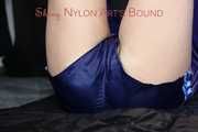 Watching sexy Pia wearing a sexy blue oldschool shiny nylon shorts and a rain jacket being tied and gagged on hands and feet on the ceiling lying on the floor (Pics)