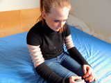 Lea wearing five very tight hose clamps on each arm