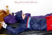 Jill tied and gagged in shiny nylon rainware