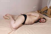 Amanda undresses and ties a man into hogtie and gag him