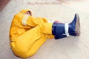 Katharina tied and gagged in a yellow rainsuit