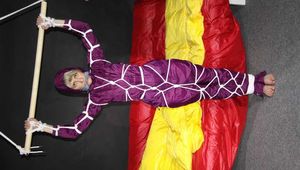 Watching sexy Sonja wearing a supersexy purple shiny nylon rainwear combination being tied and gagged overhead with ropes and a clothgag (Pics)