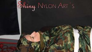 Sexy PIA being tied and gagged with tape and a clothgag on the sofa wearing a camouflage rainsuit and yellow rubber boots (Pics)