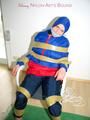 Katharina tied by using tape, gagged and hooded on a chair wearing sexy red/blue rainwear (Pics)