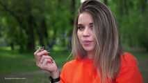 Pretty Kate is smoking Marlboro Red 100s in the park