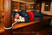 Jill tied and gagged in shiny rainwear