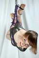 Barefoot Amanda in leotard, suspended sideways with hemp rope, dangles in tha air