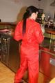 Jill posing in a bar wearing a sexy red rainwear combination with nothing under it (Pics)