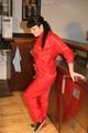 Jill posing in a bar wearing a sexy red rainwear combination with nothing under it (Pics)