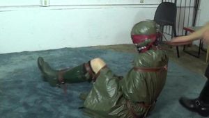 Ana in green raincoat bondage