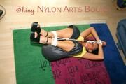 Stella tied and gagged on the floor wearing a shiny nylon rain pants (Pics)