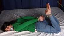 Roxana hogtied on bed