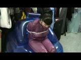Video with Jill tied and gagged in a shiny purple semi transparent PVC suit