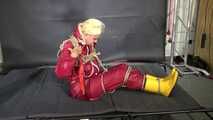 Alice bound and gagged in a nylon Rainsuit