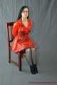 Bound in PVC minidress and red raincoat
