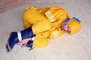 Katharina tied and gagged in a yellow rainsuit