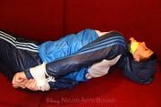 Isabelle tied and gagged in shiny nylon clothes