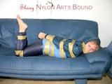 Leoni tied, gagged and hooded with tape wearing a sexy blue rainwear combination (Pics)