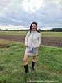 Miss Amira in plastic raincoat and PVC shorts