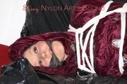 Lucy tied, gagged and hooded on a sofa wearing a sexy darkred downwear combination (Pics)