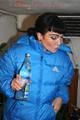 Jill posing in a cooling room wearing a shiny nylon rainpants and a down jacket (Pics)