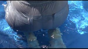 Pia ties and gagges herself in a small swimming pool wearing sexy grey rainwear (Video)