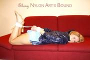 Samantha tied and gagged on a sofa wearing a hot lightblue shiny nylon shorts and a very shiny blue rian jacket (Pics)