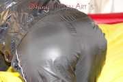 Lucy preparing her bed and enjoys it wearing sexy black rainwear (Pics)