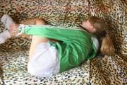 Leonie tied and gagged on a sofa wearing a white shiny nylon shorts and a green rain jacket (Pics)