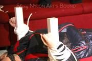 Mara tied and gagged on a bottom-up table wearing a supersexy black/red downwear combination (Pics)