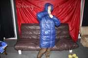 Sexy Sonja changing clothes to a brown down pants and a blue down jacket and lolling on the sofa (Pics)