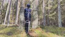 Sebastien breathplay tied up in a puffer jacket among the trees.