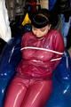 Jill tied and gagged in a semi-transparent purple PVC suit