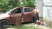 Mistress Jenna stands on the slave with a car while smoking in the slave's mouth B