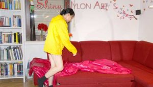 Lucy wearing a sexy red shiny nylon shorts and a yellow rain jacket preparing the sofa to lay down (Pics)
