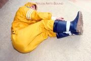 Katharina tied and gagged in a yellow rainsuit