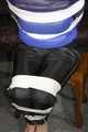 Sexy Mara wearing a black rain pants and a blue/black down jacket being tied, gagged and hooded with tape and clothgag (Pics)