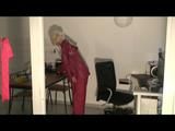 Blonde-haired archive girl being at home wearing shiny nylon rainwear (Video)