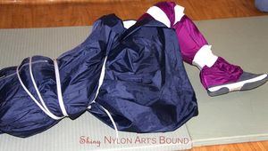 Katharina tied and gagged in a shiny nylon rainsuit and a raincape