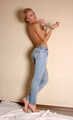Topless barefoot Samira, cuffed with steel cuffs, poses to the camera