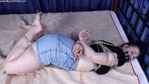 Josefa hogtied on bed