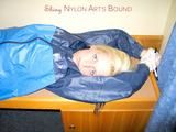 Archive girl tied and gagged with tape and rope wearing shiny nylon rainwear in blue (Pics)