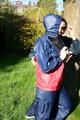 Jill and her friend in the garden playing with eachother wearing sexy shiny nylon rainwear (Pics)