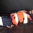 Sexy Sandra being tied and gagged with tape on a bed wearing blue rainwear and a lifevest (Video)
