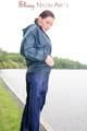 Sexy archive girl wearing a blue rain pant and rain jacket walking on a lake in freetime (Pics)