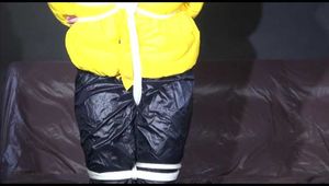 MARA tied and gagged overhead with ropes and a ballgag wearing a super sexy super shiny black rain pants, rubber boots and a yellow down jacket (Video)